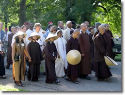 Thich Nhat Hanh walking with a group of people